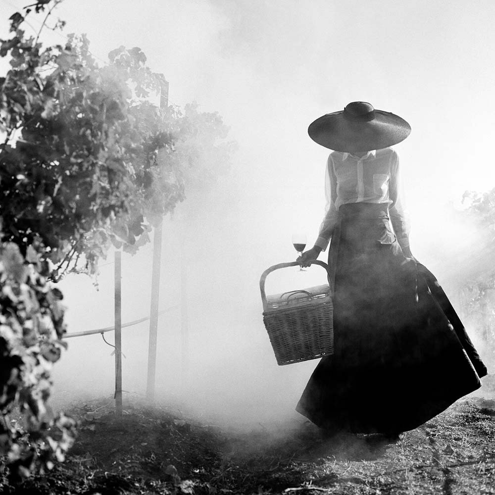 Woman Holding up Dress Walking through Vineyard, Napa Valley, California,  1998© Rodney Smith